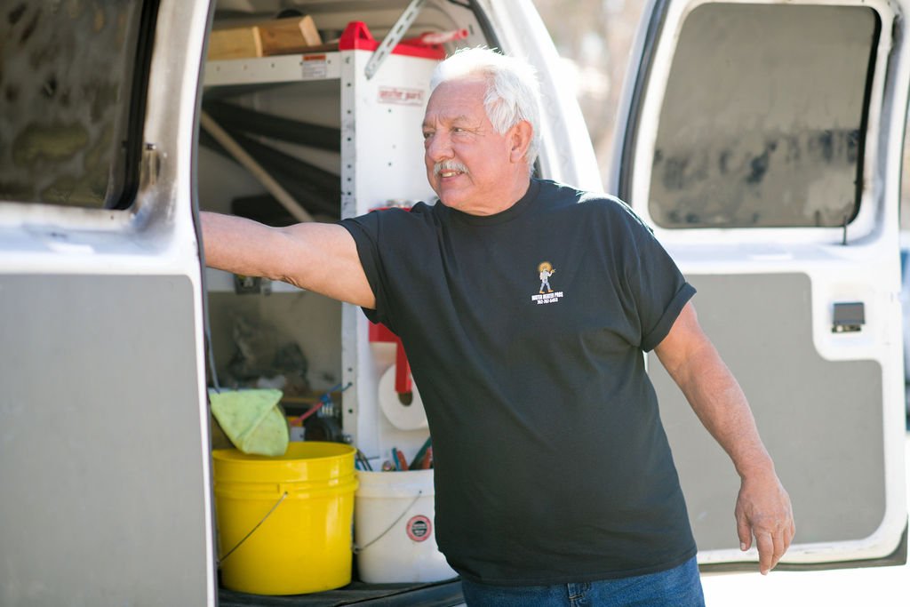 Water Heater Pro plumber getting a tool out of his van